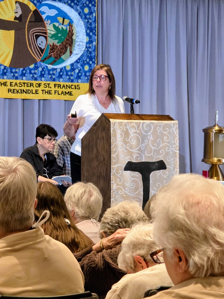 Layna, Formation Commission leader, speaking at the podium. New Formation materials are coming!